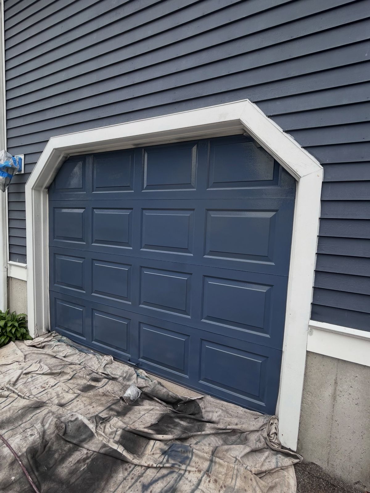 Dark gray garage door with fresh white trim