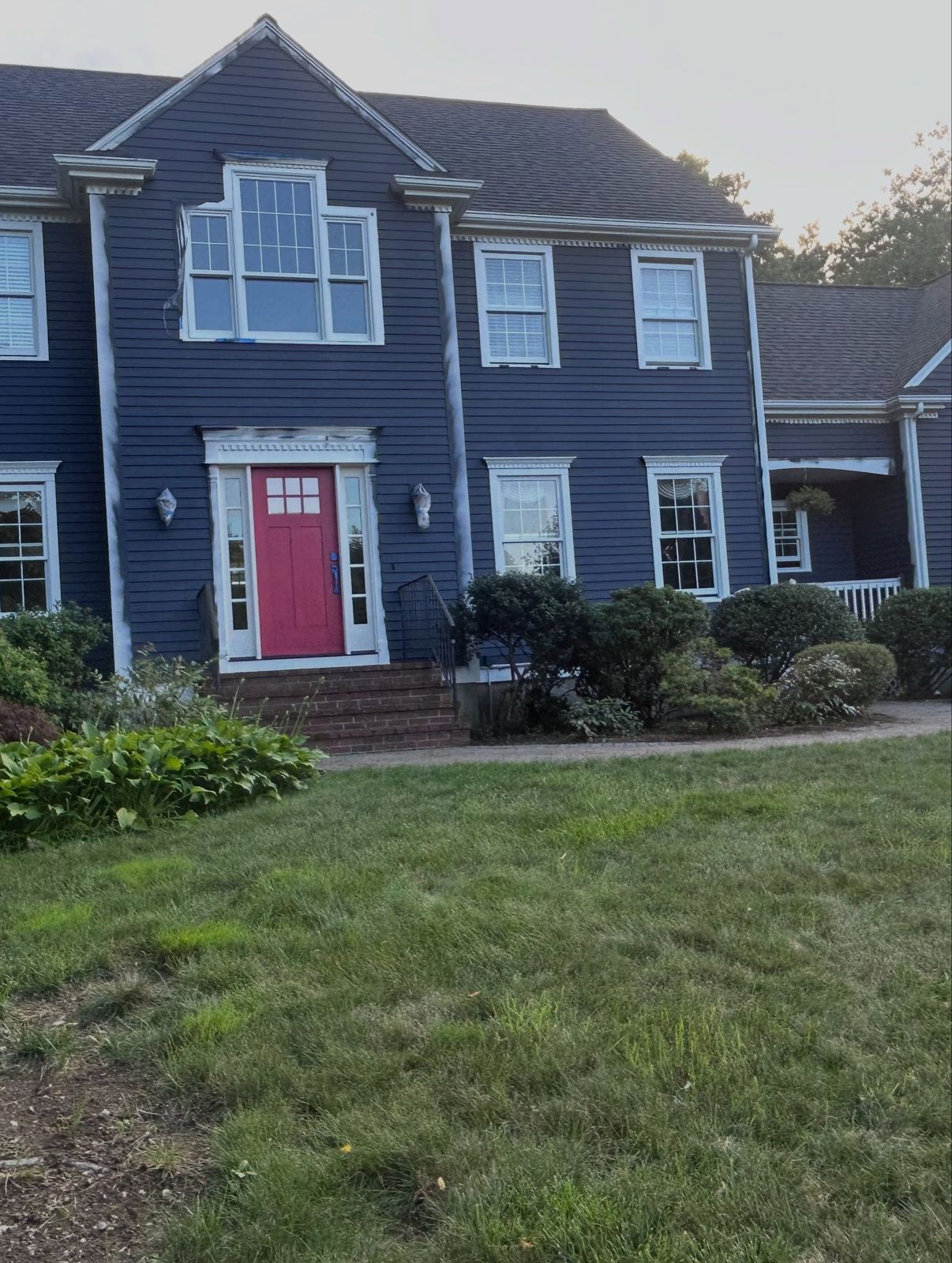 Colonial exterior with navy siding and white trim